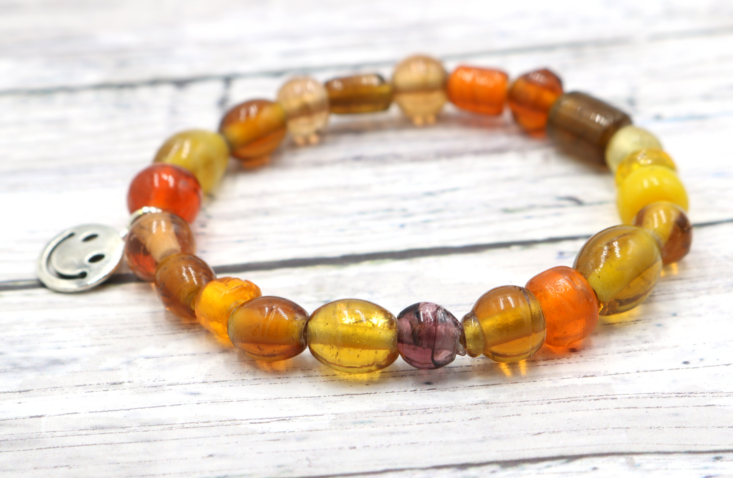 Yellow Hued Warm Artisan Glass Beads Bracelet with Silver Smile Face Charm by Monkey's Mojo