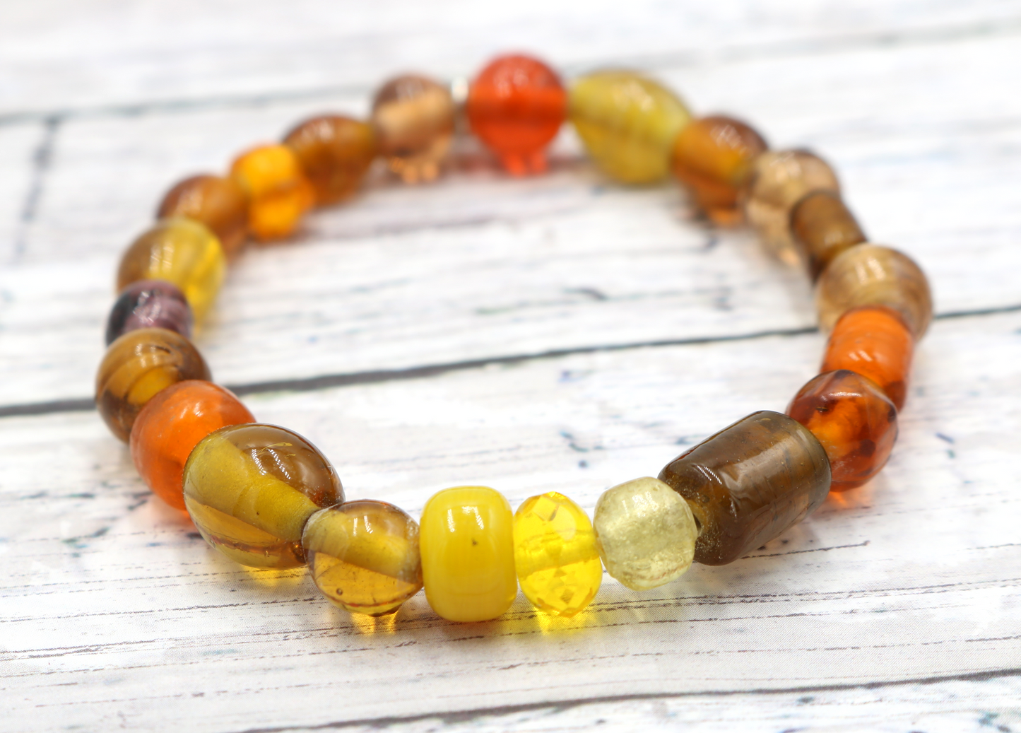 Yellow Hued Warm Artisan Glass Beads Bracelet with Silver Smile Face Charm by Monkey's Mojo
